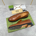 Brown leather loafer with slip-on vamp and stitched penny strap detail