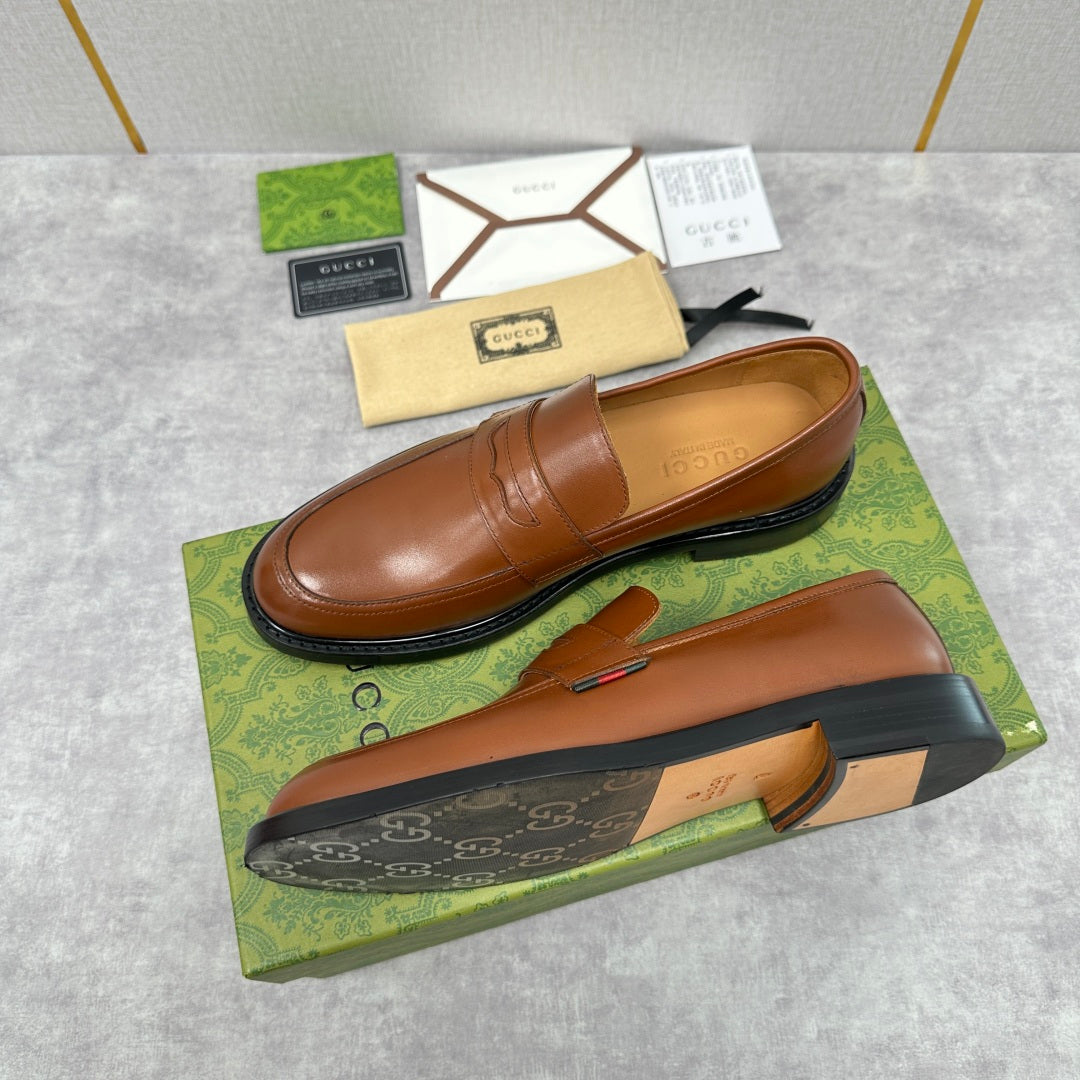 Brown leather loafer with slip-on vamp and stitched penny strap detail