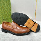 Brown leather loafer with embossed logo outsole and penny strap upper