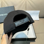 Black baseball cap with front label patch and eyelet detail on brim.