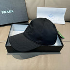 Black baseball cap on display box, with front logo detail and curved brim.