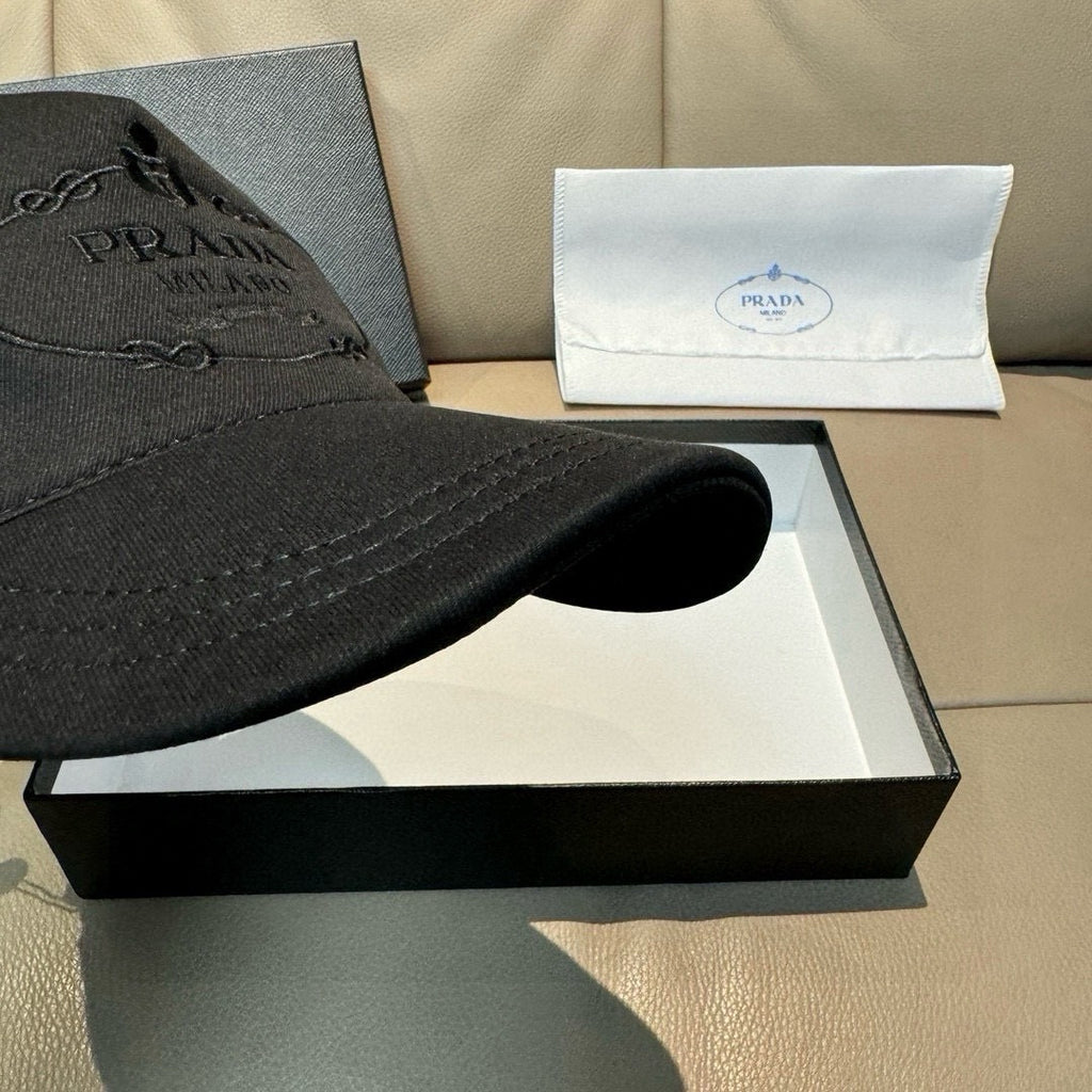 Black baseball cap brim close-up, with stitched edge and curved silhouette.