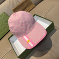 Gucci cap in pink with GG monogram pattern, striped band, and gold bee emblem