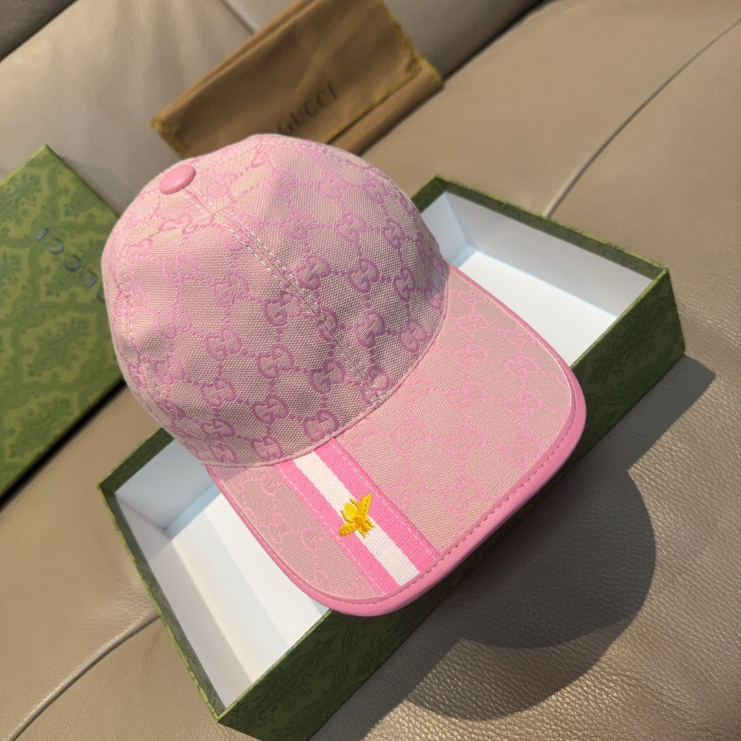 Gucci cap in pink with GG monogram pattern, striped band, and gold bee emblem