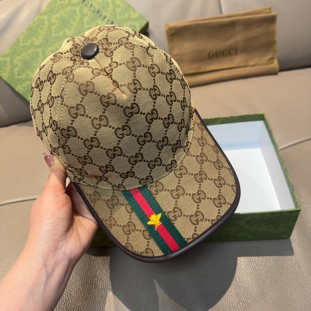 Gucci tan baseball cap with GG pattern and green/red stripe with yellow star, handheld view