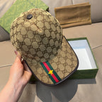 Gucci tan baseball cap with GG pattern and green/red stripe with yellow star, handheld view