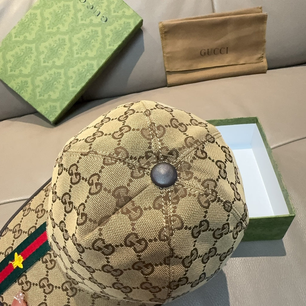 Gucci tan baseball cap top view with GG pattern and round metal button