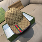 Tan Gucci baseball cap with GG pattern, green/red stripe and yellow star emblem