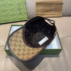 Gucci baseball cap with tan GG brim and black interior crown, tag visible inside
