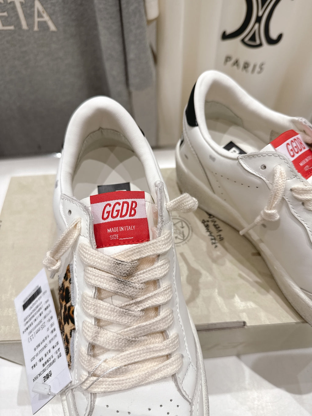 White lace-up sneakers with G GDB tongue label and perforated toe