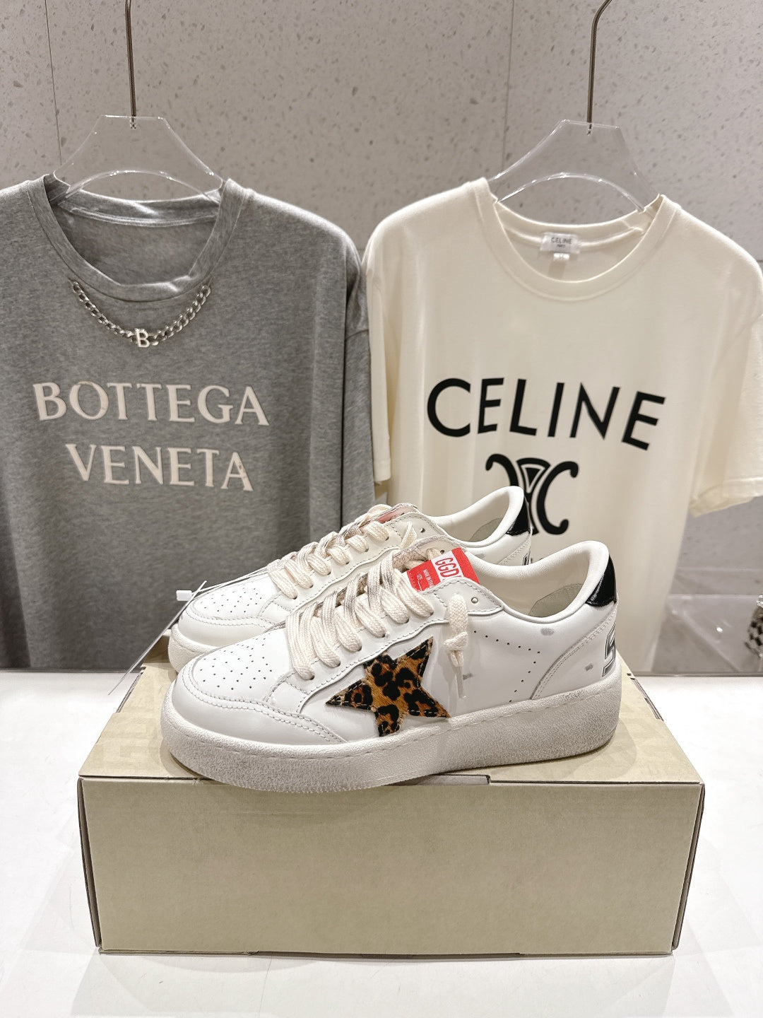 White sneakers with leopard-print side patch and lace-up laces