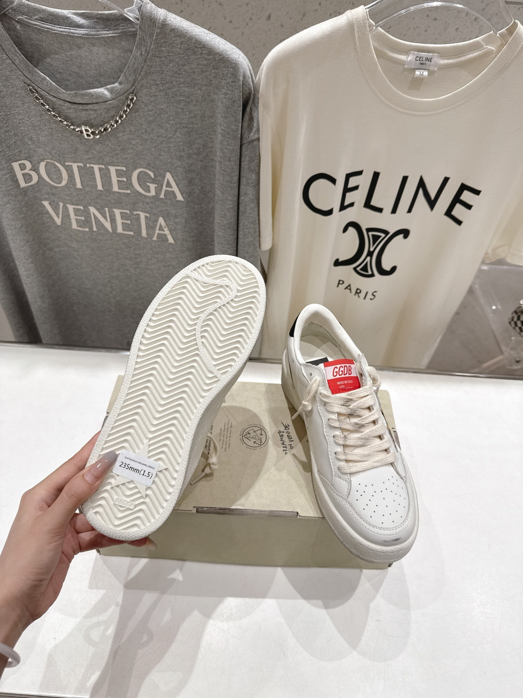 White sneakers with patterned rubber outsole and lace-up front