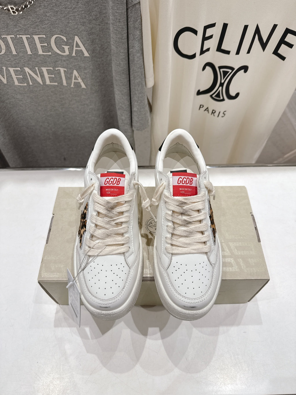 White lace-up sneakers with perforated toe and leopard side patch detail