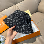 Louis Vuitton bucket hat with dark monogram print, top view, curved brim detail.