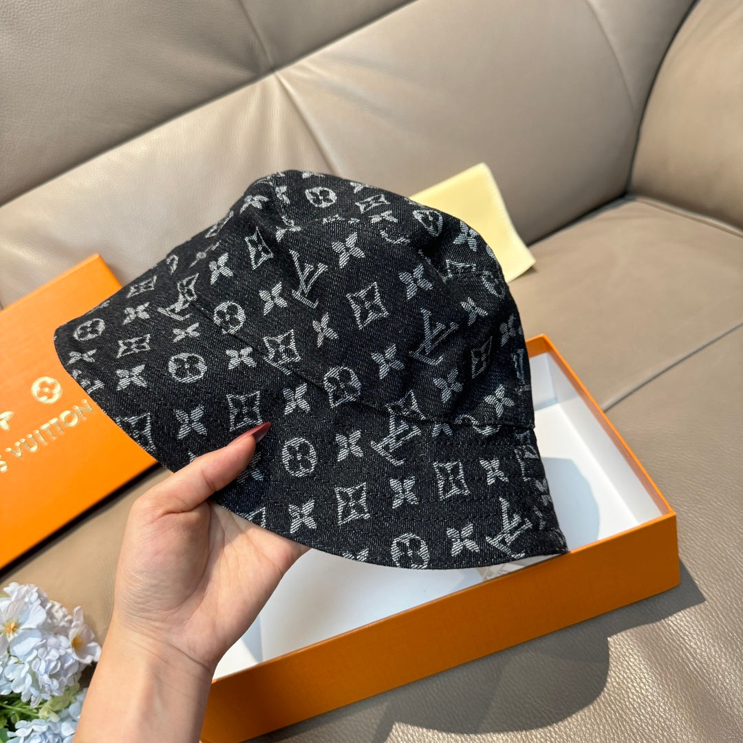 Louis Vuitton bucket hat with dark monogram print, top view, curved brim detail.