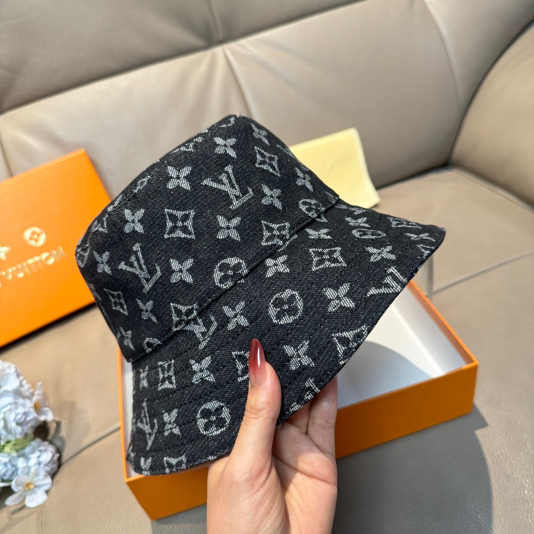 Louis Vuitton bucket hat with dark monogram pattern, curved brim, angled view.