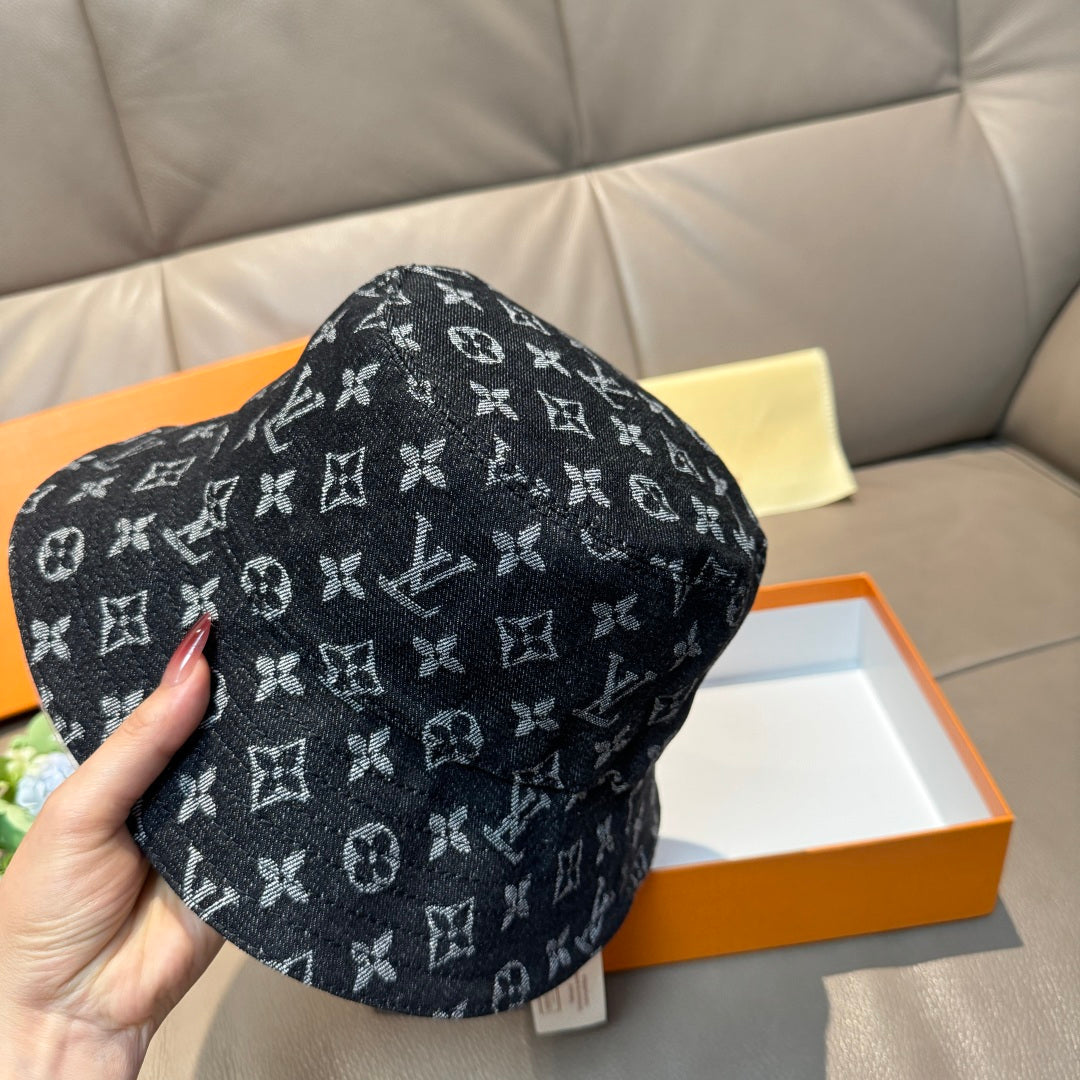 Louis Vuitton bucket hat with dark monogram print, hand-held side angle.