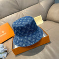 Louis Vuitton denim-blue monogram bucket hat with stitched brim and crown.