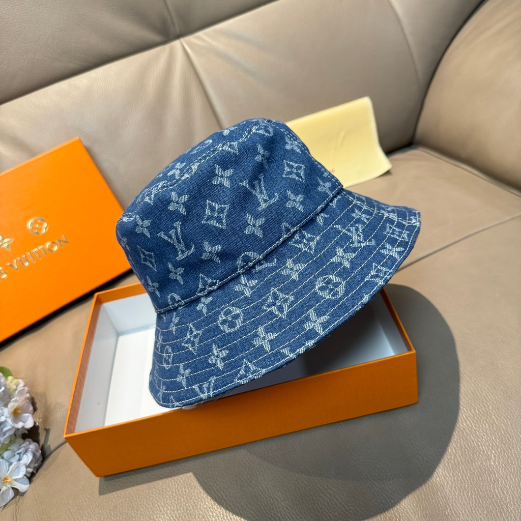 Louis Vuitton denim-blue monogram bucket hat, angled view on display.