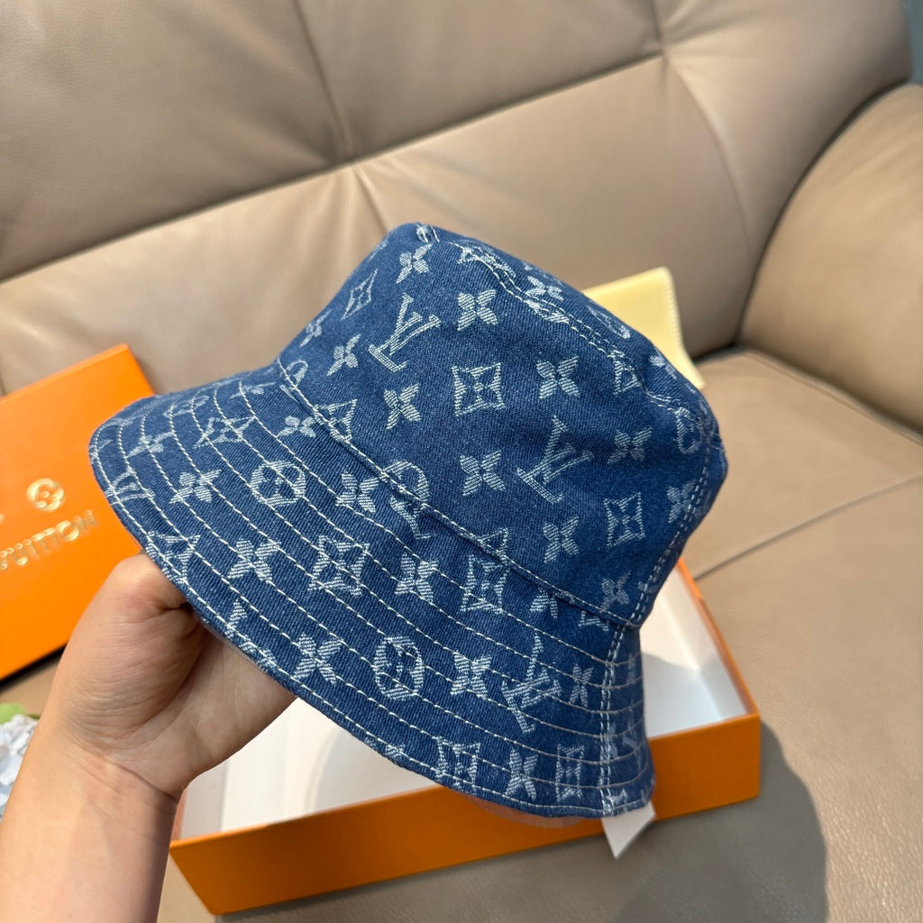 Louis Vuitton denim-blue monogram bucket hat with side pattern detail.