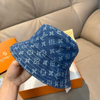 Louis Vuitton denim-blue monogram bucket hat with side pattern detail.