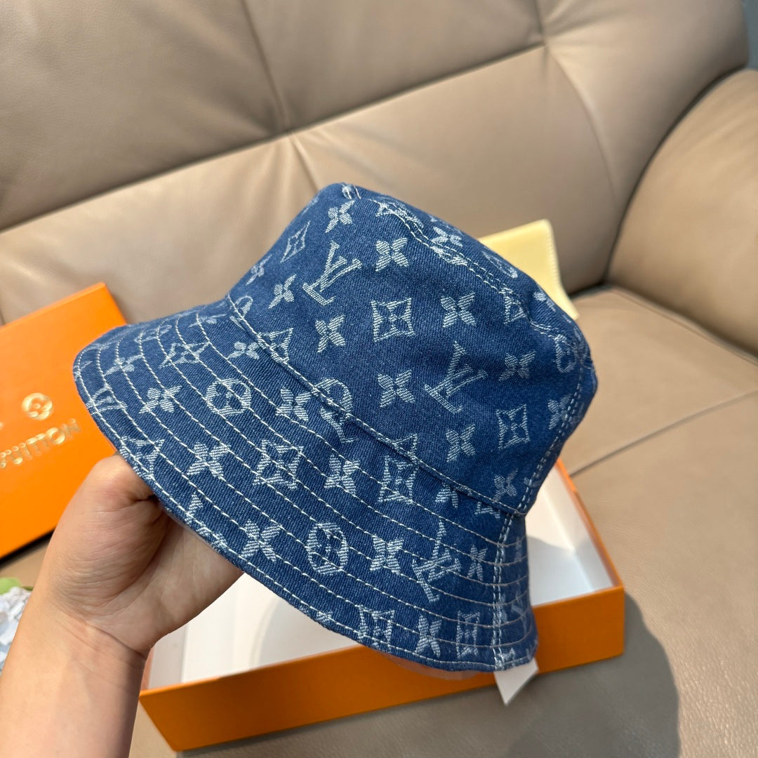 Louis Vuitton denim-blue monogram bucket hat with side pattern detail.