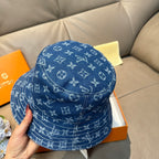 Louis Vuitton denim-blue monogram bucket hat, back and side pattern visible.