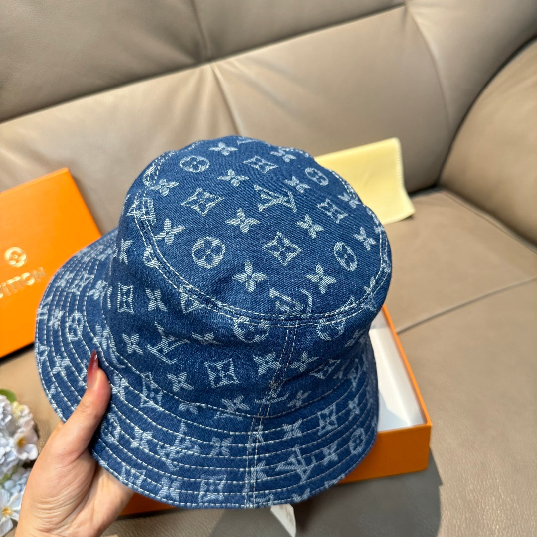 Louis Vuitton denim-blue monogram bucket hat, back and side pattern visible.