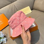 Louis Vuitton pink monogram bucket hat, three-quarter view held in hand
