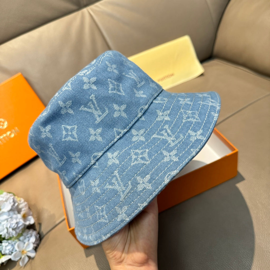 Louis Vuitton blue monogram bucket hat, held up for a side/front angle