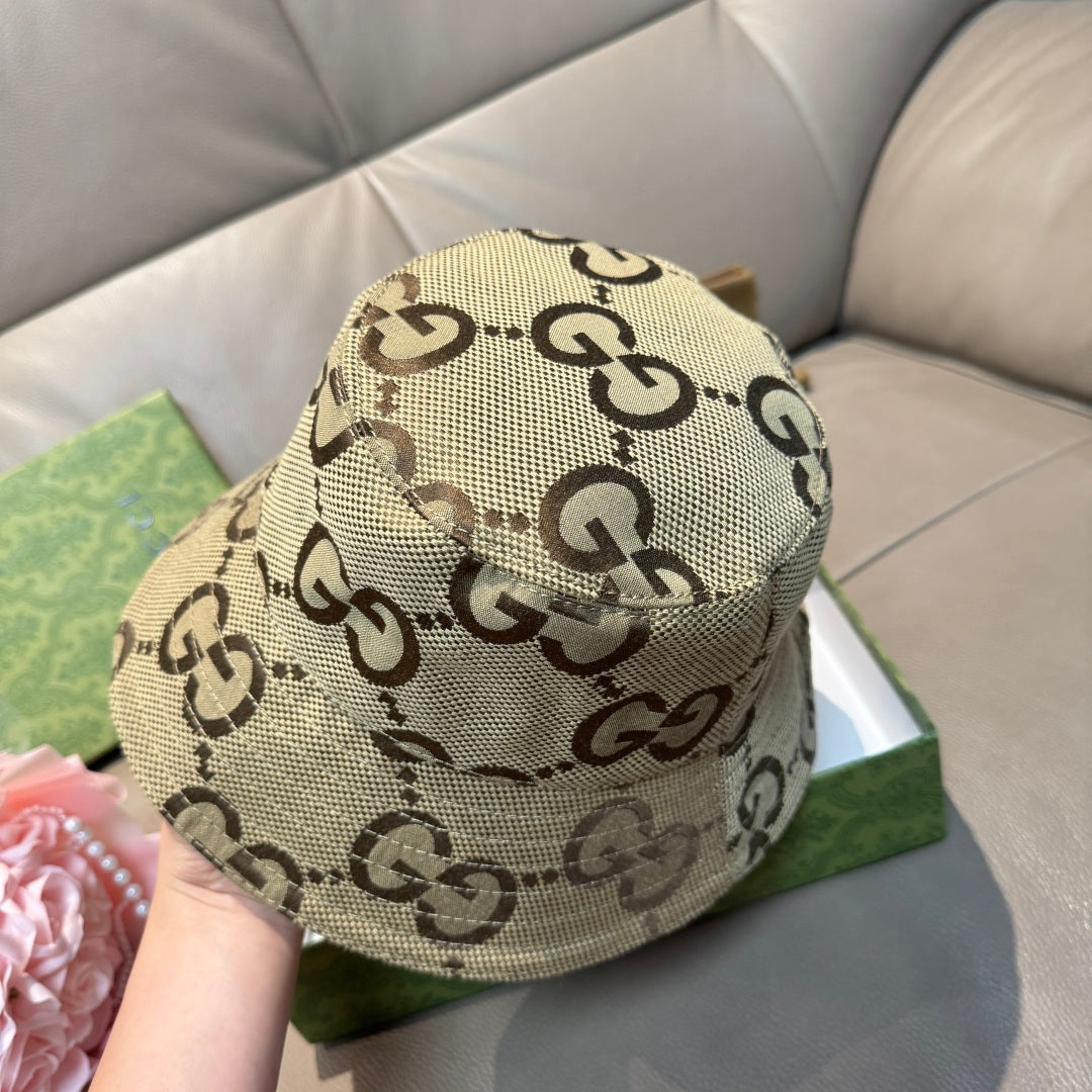 Tan GG monogram bucket hat with allover pattern, held and viewed from front