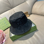 Gucci bucket hat in dark GG monogram fabric, side profile with curved brim.