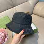 Gucci bucket hat, dark GG monogram print, with curved brim and crown.