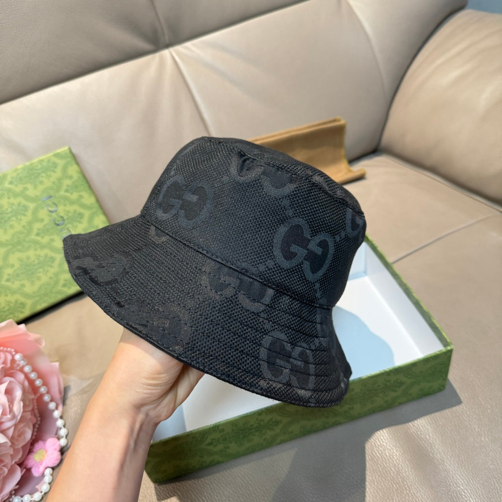 Gucci bucket hat with dark GG monogram print, angled view of brim and crown.