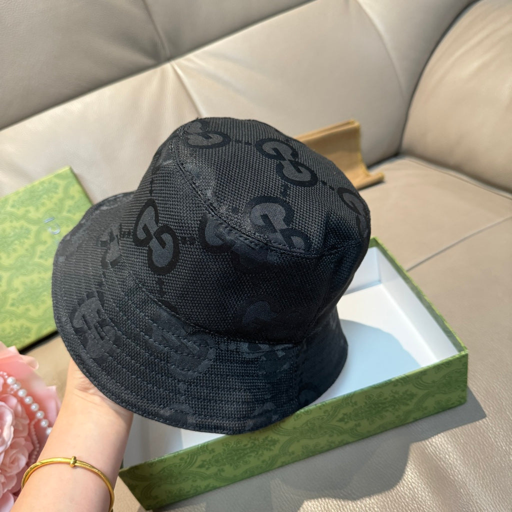 Gucci bucket hat in dark GG monogram fabric, close view of top panel.