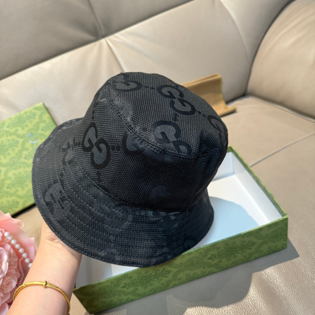 Gucci bucket hat in dark GG monogram fabric, close view of top panel.