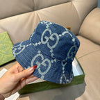 Denim bucket hat with GG monogram pattern, blue, handheld close-up of brim