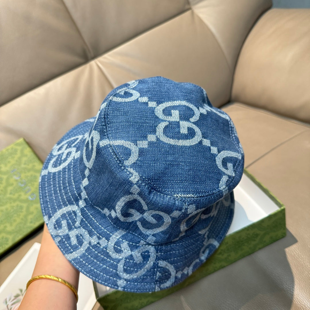 Gucci blue bucket cap with white GG logo pattern, back view with curved brim.