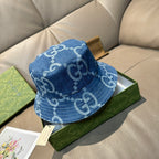 Gucci blue bucket cap with allover white GG logo print, folded crown detail.