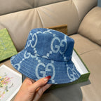 Gucci blue GG-print bucket cap, side view with curved brim and top panel.