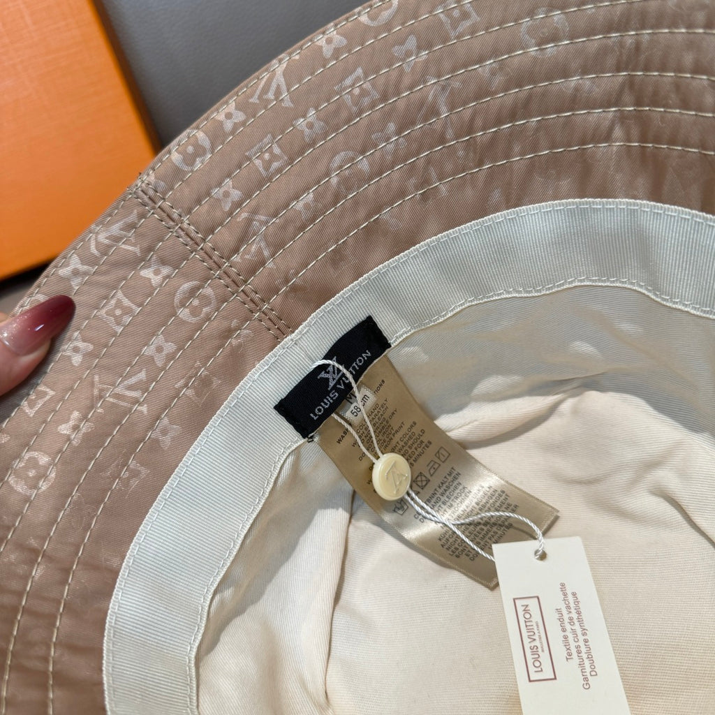Louis Vuitton bucket hat inside brim close-up with tags on cream lining
