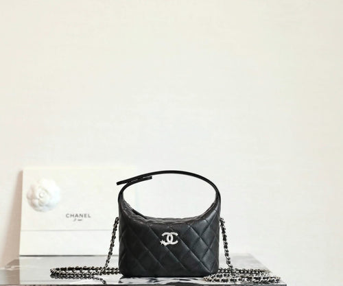 Black quilted handbag with chain strap and Chanel logo front, top handle
