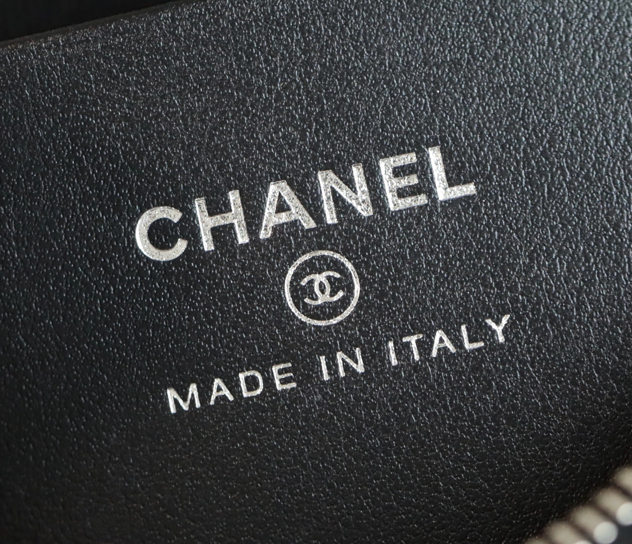 Chanel logo and 'Made in Italy' stamp on black leather