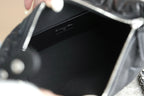 Black handbag interior with logo stamp, open top with chain strap