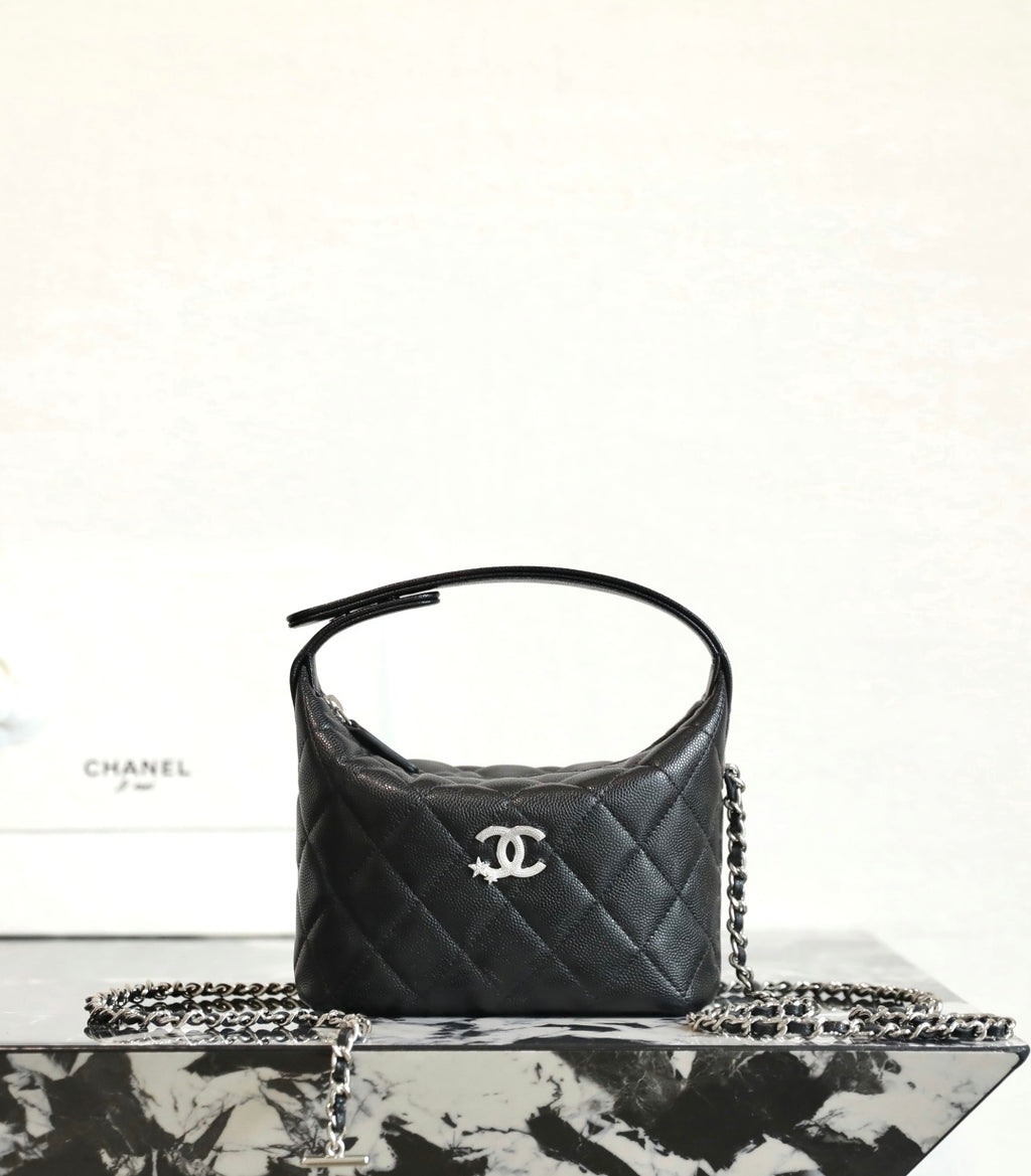 Black quilted handbag with top handle and silver chain strap, Chanel logo