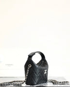 Black quilted mini handbag with chain strap and Chanel emblem, side view