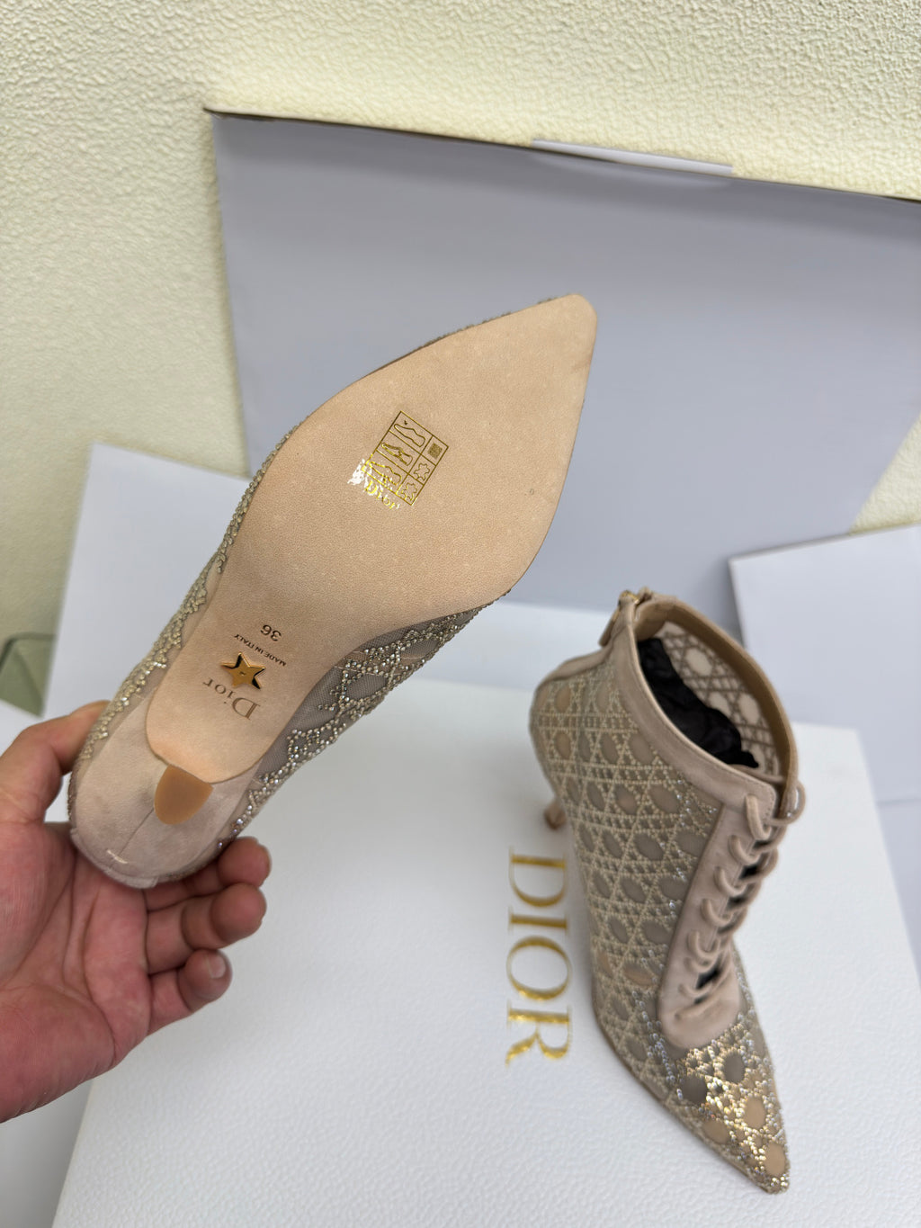 Women’s ankle boot sole and side view, beige patterned upper
