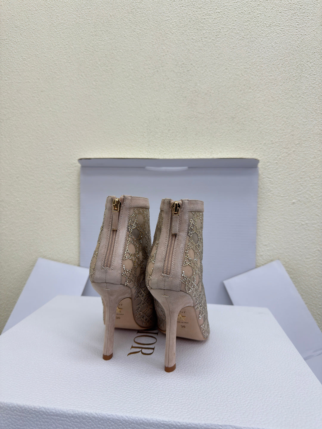 Women’s heeled ankle boots with zip closures and beige patterned uppers
