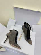 Pair of women’s monogram lace-up ankle boots, pointed toe, stiletto heel