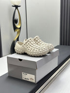 Balenciaga white slip-on sandals, side view with grid-pattern upper and tread sole